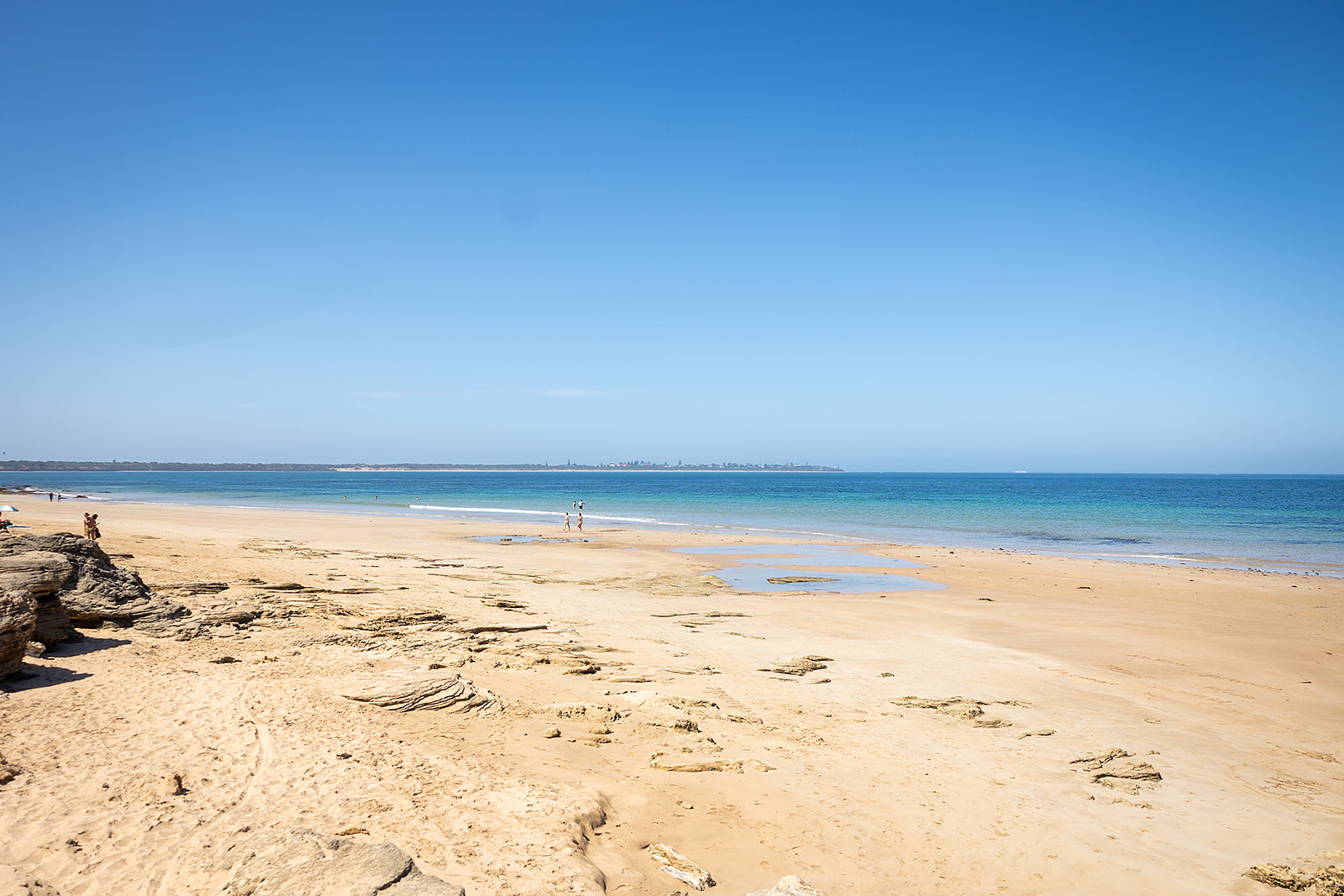 Open sandy beach and calm blue water at Point Lonsdale